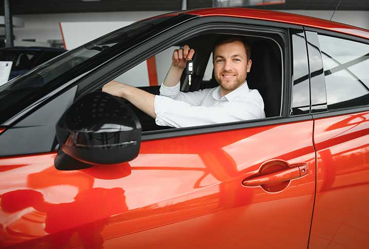 Man in the car showing key